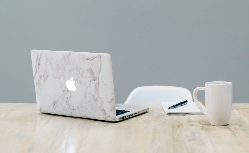 Laptop and notebook on minimalist desk